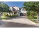 Two-story home featuring a well-manicured lawn, two-car garage, and welcoming front porch at 13525 Gorgona Isle Dr, Windermere, FL 34786