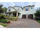 Charming two-story home with a two-car garage and a beautifully landscaped front yard at 13525 Gorgona Isle Dr, Windermere, FL 34786