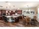 Modern kitchen with dark wood cabinetry, an expansive island, and stainless-steel appliances at 13525 Gorgona Isle Dr, Windermere, FL 34786