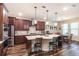Spacious kitchen featuring a large island with seating, stainless steel appliances, and dark wood cabinets at 13525 Gorgona Isle Dr, Windermere, FL 34786
