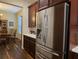 Spacious kitchen with stainless steel refrigerator, dark wood cabinets, and white countertops at 13525 Gorgona Isle Dr, Windermere, FL 34786