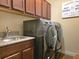 This laundry room has modern appliances, granite countertops, and wooden cabinets at 13525 Gorgona Isle Dr, Windermere, FL 34786