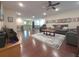 Open upstairs living area with hardwood floors, neutral paint, a ceiling fan, and comfortable seating at 13525 Gorgona Isle Dr, Windermere, FL 34786