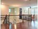 Bright loft area with hardwood floors, overlooking the living spaces below, and a bedroom or playroom off to the right at 13525 Gorgona Isle Dr, Windermere, FL 34786