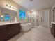 Spa-like bathroom offers a soaking tub, glass-enclosed shower, and a stained-glass window at 13525 Gorgona Isle Dr, Windermere, FL 34786