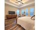Spacious main bedroom with modern ceiling fan, wood-look tile floors, and natural light at 13525 Gorgona Isle Dr, Windermere, FL 34786