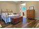 Relaxing main bedroom features wood-look tile flooring and a view to the ensuite bathroom at 13525 Gorgona Isle Dr, Windermere, FL 34786