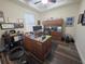 This home office has hardwood floors, a ceiling fan, a window, and an oak desk and storage at 13525 Gorgona Isle Dr, Windermere, FL 34786