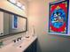 Charming powder room features a custom stained-glass window and modern fixtures at 13525 Gorgona Isle Dr, Windermere, FL 34786