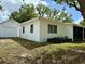 Backyard featuring a detached garage, green space, and a white house at 1505 Piedmont Dr, Deltona, FL 32725