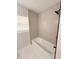 Bathroom featuring shower with neutral vertical tiling and a shower head at 1505 Piedmont Dr, Deltona, FL 32725