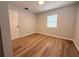 Bedroom featuring modern flooring and bright natural light from one window at 1505 Piedmont Dr, Deltona, FL 32725