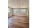 Bedroom features updated flooring, two windows, and neutral paint at 1505 Piedmont Dr, Deltona, FL 32725