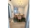 Charming dining room features a round wood table, modern chandelier, and colorful rug, perfect for gatherings at 1505 Piedmont Dr, Deltona, FL 32725