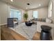 Cozy living room with stylish furniture, neutral tones, and hardwood flooring offers a great space to relax at 1505 Piedmont Dr, Deltona, FL 32725