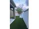 A backyard featuring artificial grass, a white fence, and two chairs, creating an inviting outdoor space at 11578 Ashlin Park Blvd, Windermere, FL 34786