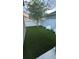 Backyard with artificial grass, white fence, and two chairs, perfect for outdoor enjoyment at 11578 Ashlin Park Blvd, Windermere, FL 34786