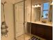 Bright bathroom with shower, double sink vanity, and neutral tile at 11578 Ashlin Park Blvd, Windermere, FL 34786