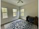 Bedroom with three windows, a ceiling fan, light walls and a desk at 11578 Ashlin Park Blvd, Windermere, FL 34786