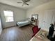 A simple bedroom with a ceiling fan, natural light, and hardwood floors at 11578 Ashlin Park Blvd, Windermere, FL 34786