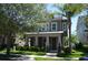 Charming two-story home featuring a welcoming front porch and well-manicured landscaping at 11578 Ashlin Park Blvd, Windermere, FL 34786
