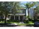 Charming two-story home featuring a welcoming front porch and well-manicured landscaping at 11578 Ashlin Park Blvd, Windermere, FL 34786