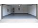 A spacious two-car garage with an open layout, painted floor, and convenient access to the house at 11578 Ashlin Park Blvd, Windermere, FL 34786
