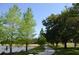 A scenic view of a winding path surrounded by lush green trees and tranquil water at 11578 Ashlin Park Blvd, Windermere, FL 34786