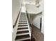 Elegant staircase with dark wood steps, iron railings, and abundant natural light at 11578 Ashlin Park Blvd, Windermere, FL 34786