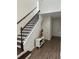Staircase with dark wood steps and wrought iron railings, leading to a bright entryway at 11578 Ashlin Park Blvd, Windermere, FL 34786