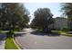 Serene neighborhood street lined with mature trees, showcasing a peaceful residential setting at 11578 Ashlin Park Blvd, Windermere, FL 34786