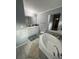 Bathroom featuring a tub with decorative tile, a double sink vanity, and updated fixtures at 118 Jana Cir, Auburndale, FL 33823