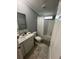 Neutral bathroom featuring a white vanity, toilet, and shower with a white curtain at 118 Jana Cir, Auburndale, FL 33823