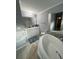 Bathroom featuring a tub with decorative tile, a double sink vanity, and updated fixtures at 118 Jana Cir, Auburndale, FL 33823