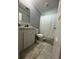 Neutral bathroom featuring a white vanity, toilet, and shower with a white curtain at 118 Jana Cir, Auburndale, FL 33823