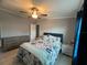 Inviting bedroom featuring wood-look tile flooring, ceiling fan, and comfortable decor at 118 Jana Cir, Auburndale, FL 33823