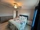 Bright bedroom featuring a ceiling fan, wood-look tile flooring, and neutral wall color at 118 Jana Cir, Auburndale, FL 33823
