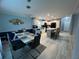 Open dining area features a modern light fixture and flows into the kitchen with a breakfast bar at 118 Jana Cir, Auburndale, FL 33823