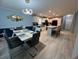 Open-concept dining area flowing into a modern kitchen with granite island seating at 118 Jana Cir, Auburndale, FL 33823