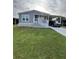 Charming single-story home featuring a carport and well-maintained lawn at 118 Jana Cir, Auburndale, FL 33823