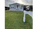 Charming single-story home featuring a carport and well-maintained lawn at 118 Jana Cir, Auburndale, FL 33823