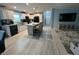 Modern kitchen with white cabinets, granite countertops, and bar stool seating at 118 Jana Cir, Auburndale, FL 33823