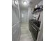 Modern laundry room featuring stainless steel washer and dryer, and storage at 118 Jana Cir, Auburndale, FL 33823