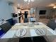 Bright, open floor plan features a kitchen, dining area, and living space with comfortable seating at 118 Jana Cir, Auburndale, FL 33823
