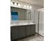 Bathroom featuring double sinks, modern lighting and large walk-in shower at 1351 Pompay Dr, Davenport, FL 33896