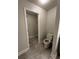 Bathroom featuring a toilet and view into a walk-in closet at 1351 Pompay Dr, Davenport, FL 33896