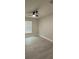 This bedroom has a ceiling fan, light gray walls and a window at 1351 Pompay Dr, Davenport, FL 33896