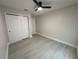 Bedroom featuring a ceiling fan and closet with gray wood-look flooring at 1351 Pompay Dr, Davenport, FL 33896