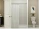 A well-lit bathroom features a tiled shower, toilet, and modern decor, showcasing a clean and functional design at 1918 Sarah Ln, Winter Haven, FL 33884