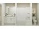 Clean bathroom featuring a bathtub with shower, white cabinets and modern toilet at 1918 Sarah Ln, Winter Haven, FL 33884